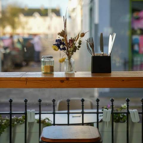 The window bar with dried flowers and cutlery
