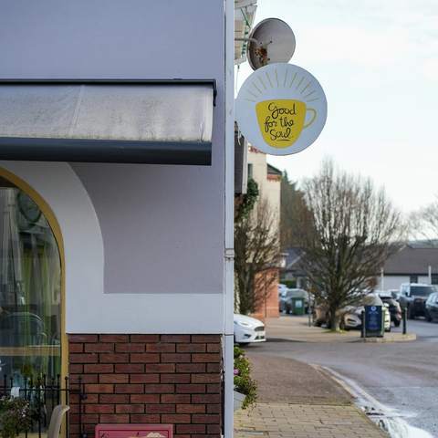 The corner of the building with the round Good for the Soul sign