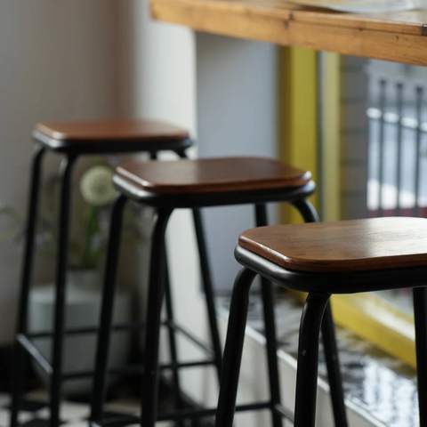 Bar stools by the yellow window frames